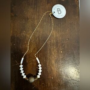 Elegant Gold and White Necklace by Betsy Pittard.